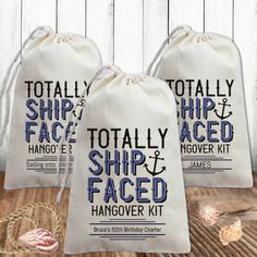 two bags with the words totally ship faced hangover kit printed on them, sitting on a wooden floor