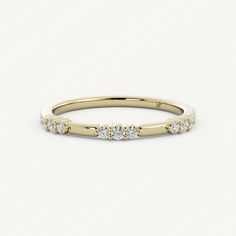 a yellow gold ring with three diamonds