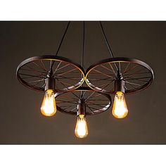 three light bulbs hanging from the ceiling in an industrial style chandelier with wheels and spokes