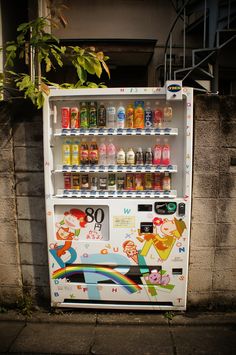 a vending machine sitting on the side of a street