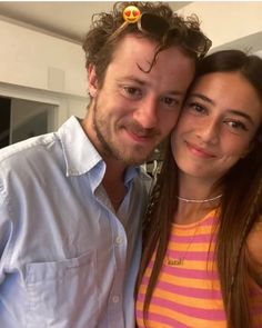 a man standing next to a woman in a kitchen