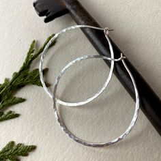 These lightweight hammered hoops are perfect for daily wear. They have a nice hammered texture and an easy to close capture.  Material: sterling silver  Diameter: 5 cm Also available in other metal and smaller sizes. Hoop Earrings Diy, Handmade Silver Jewellery, Beaded Earrings Diy, Hammered Hoop Earrings, Mini Hoop Earrings, Eco Friendly Jewelry, Nature Inspired Jewelry, Beaded Hoop Earrings, Inspired Jewelry