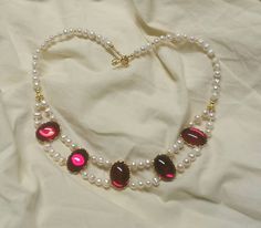 This necklace is 18in long, and is made with gold wash accents, freshwater pearls and crimson red jewel cabochons. The stones can come in different colors!  This necklace is sure to be a sumptuous addition to any attire. Giftwrap is available, as are pearl earrings to match! Red Pearl Necklace With Pearl Drop, Red Pearl Necklace With Pearl Chain, Red Ruby Cabochon Necklace, Pearl Collar, Red Jewel, Indian Jewelry Sets, Jewellery Sets, Crimson Red, Gold Wash