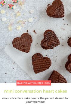 heart shaped chocolate cakes on top of a white tablecloth with text overlay reading mini conversation heart cakes most chocolate cake hearts, the perfect dessert for your valentine's day