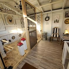 the inside of a house with wood floors and white walls, decorated with black and white decorations