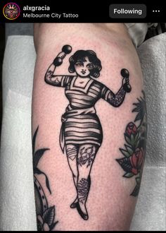 a woman with a tattoo on her leg holding a juggling stick and looking at the camera