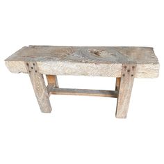 a wooden bench made out of wood with nails on the bottom and legs, sitting in front of a white background