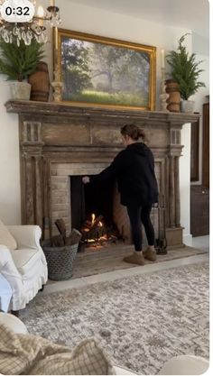 a woman standing in front of a fire place