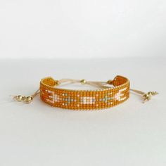 an orange beaded bracelet on a white surface