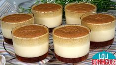 four desserts are sitting on a glass plate