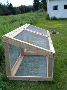 an outdoor chicken coop in the grass