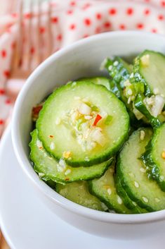 cucumbers with sesame seeds in a white bowl