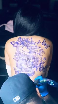 a woman with tattoos on her back