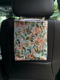 the back seat of a car with a pillow on it