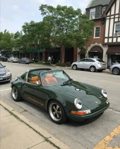 a green sports car parked on the side of the road