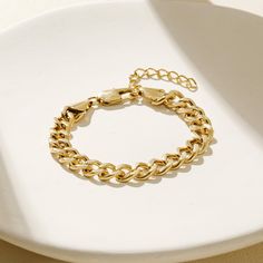 This classic link chain bracelet is 18K gold plated on durable stainless steel. An elegant and timeless option, the link chain bracelet is perfect for everyday wear. Classic Cuban Link Chain Bracelet For Everyday, Gold Stainless Steel Jubilee Chain Link Bracelet, Stainless Steel Gold Jubilee Chain Link Bracelet, Everyday Cuban Link Chain Bracelet With Solid Links, Elegant Cuban Link Chain Bracelet, Everyday Gold-plated Cuban Link Bracelet, Everyday Gold Plated Cuban Link Bracelet, Elegant Cuban Link Chain Bracelet With Solid Links, Elegant Cuban Link Chain Bracelet With Solid Construction