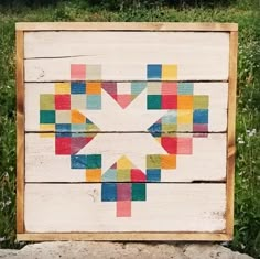 a wooden sign with colorful squares on it