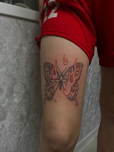 a woman with a butterfly tattoo on her leg