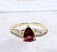 Don't miss this opportunity to own this beautiful gemstone ring crafted in 14k gold filled => Gemstone Type - Garnet, Clear quartz => Gemstone Size - 5*7 mm => Gemstone Cut - Faceted => Total Number of Gemstones - 7 => Metal Type - 14k Gold Filled (Tarnish Resistant And Nickel Free) - also available in 925 sterling silver * Please contact me for pricing on a sizes larger than 11 * ~ Feel free to ask me about custom made designs. ❏ Replacements and custom orders : ✪ 925 sterling silver - no addit Elegant Teardrop Crystal Ring With Gemstone, Pear-shaped Ruby Ring With Center Stone, Red Pear-shaped Ruby Ring With Center Stone, Fine Jewelry Red Teardrop Ruby Ring, Teardrop Rings With Gemstone Accents For Anniversary, Pear-shaped Gold Ring With Gemstone Accents, Teardrop Gemstone Ring For Proposal, Teardrop Promise Ring With Gemstone Accents, Yellow Gold Teardrop Jewelry For Proposal