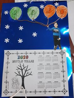 a child's handmade calendar with trees and snowflakes in the background