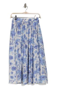 Delightful blooms romance this poplin skirt designed in a longline flared silhouette. 31 1/2" length Elastic waist Side-seam pockets 85% rayon, 15% nylon Machine wash, line dry Made in the USA of imported fabric Floral Print Flowy Midi Skirt, Floral Print Full Maxi Skirt With Voluminous Fit, Flowy Floral Print Midi Skirt, Floral Print Full Maxi Skirt, Voluminous Floral Print Full Maxi Skirt, Spring Flowy Gathered Maxi Skirt, Flowy Gathered Maxi Skirt For Spring, Voluminous Long Floral Skirt, Spring Daywear Long Skirt