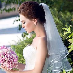 a woman in a wedding dress holding a bouquet