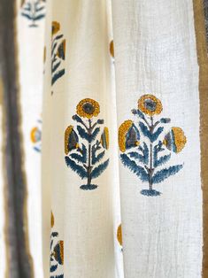 the curtains are decorated with sunflowers and leaves