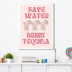 a pink poster that says save water drink tequila on the side of a white wall