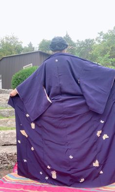 This vintage kimono is a beautifully crafted Iromuji, adorned with paper and jar motifs and features a single dual wisteria branch Kamon (family crest).  There are only few spots of fading that would be visible while worn, however barely noticeable. There is some staining on the inner silk lining, and has not been able to be removed with proper kimono dry cleaning. The staining however is not visible when worn. It is estimated that this kimono was made in the 1980's.  This kimono will likely fit Wisteria Branch, Vintage Kimono, Blue Vintage, Family Crest, Wisteria, Dress Clothes For Women, Dress Outfits, Navy Blue, Sleeve Length