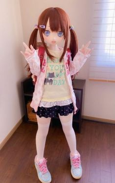 a doll is standing on the floor with her hands in the air and wearing glasses