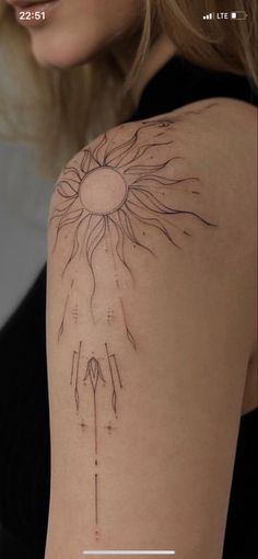 a woman's arm with a tattoo on it that has a sun in the middle