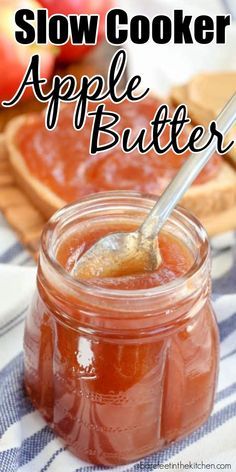 a jar filled with apple butter sitting on top of a blue and white checkered table cloth