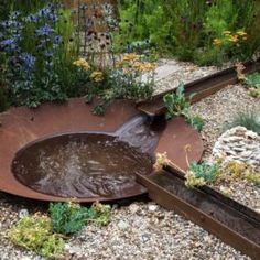 a water feature in the middle of a garden