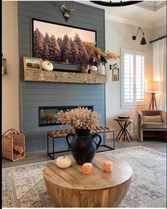 a living room filled with furniture and a fire place in front of a painting on the wall