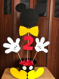 a mickey mouse cake with the number two on it's top and ears sticking out