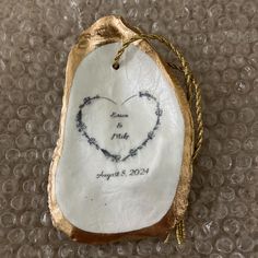 an ornament with a heart drawn on it sitting on top of a table