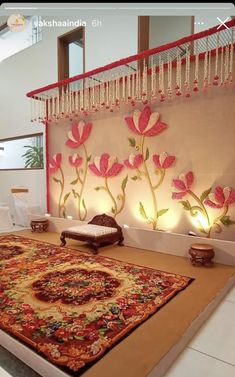 a large rug in front of a wall with flowers on it