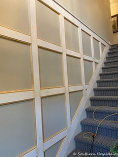 a set of stairs leading up to a wall with glass panels on the sides and bottom