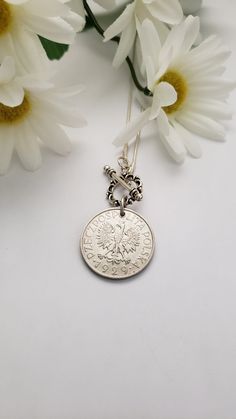 "Celebrate your Polish heritage or honor someone else's with the purchase of this necklace. It features a silver-tone 1995 1 zloty Polish coin and a repurposed white pearl bead or a 1929 coin with a front toggle closure. The coin dangles from a 16\"snake chain with a front toggle closure or an 18\" chain with a 3\" extender. The necklace will make a beautiful birthday gift. Welcome to Recycled Finery!  I repurpose old jewelry, coins, beads, vintage buttons, watch parts, and charms into new jewelry.  My ever-growing collection of these materials comes from estate sales, rummage sales, antique and thrift stores, and family and friends' collections they no longer need or want. I have fun putting these new pieces together and hope that you will find them fun to wear and as unique gifts for you Nickel Free Medallion Necklace For Anniversary, Sterling Silver Coin Necklace For Anniversary, Nickel-free Coin Medallion Necklace Gift, Classic Coin Pendant Necklace As Gift, Silver Medallion Necklace Souvenir, Silver Engraved Coin Necklace As Gift, Classic Medallion Necklace With Coin Pendant As Gift, Silver Medallion Necklace As Souvenir, Silver Medallion Necklace For Souvenirs