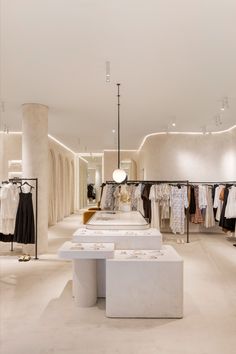 A women's clothing store, with a neutral colour palette throughout, the walls have a textured look by using french wash, and the customer island display joinery is multileveled with curved corners and tiled accents. Fashion Shop Interior, Luxury Retail Store, Fashion Store Design, Retail Interior Design, Retail Store Interior