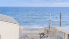 an ocean view from the top of a building with stairs leading up to the beach