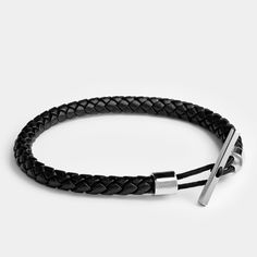 The Navis bracelet is crafted from full grain braided leather with a simple sterling silver plated toggle closure and matching crimps. This frictionless band is simple, pared down minimalism at its best. Easily dressed up for formal occasions, or left solo. Offered in 5 sizes.Masculine and unobtrusive, this elegant band is sure to become a staple in any modern man's selection of accessories. All sales for this product are final. Measure Ring Size, Snake Chain Bracelets, Grade 8, Men's Bracelet, Black Bracelets, Gold Bracelet Chain, Bracelet Collection, Ring Size Guide, Braided Leather