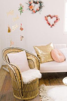 a white couch sitting next to a chair on top of a hard wood floor