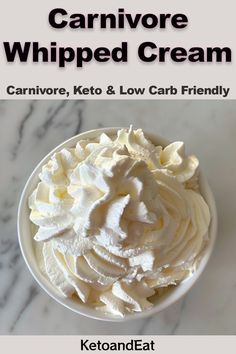 a white bowl filled with whipped cream on top of a table