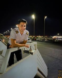 a man in uniform leaning on the edge of a ramp