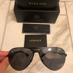 Brand New Authentic Versace Aviator Sunglasses. Black Frames With Logo On Frontier And Gold Signature Medusa’s On Side Arms . Retail $545 . From Nordstrom. Comes With Case , Box , Dust Cloth And Booklet. Unisex Designer Black Aviator Sunglasses With Tinted Lenses, Designer Black Rimless Sunglasses, Designer Black Aviator Sunglasses, Mens Glasses Fashion, Black Frames, Versace Accessories, Mens Glasses, Colored Sunglasses, Glasses Fashion