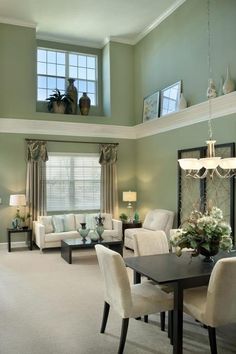 a living room filled with furniture and a chandelier hanging from the skylight