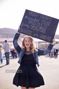 a woman holding up a sign that says you have the word to your back in mine