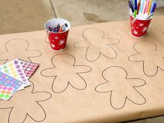 a table with some cups and markers on it