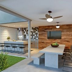 an outdoor kitchen and dining area with wood paneling on the wall, ceiling fan and television